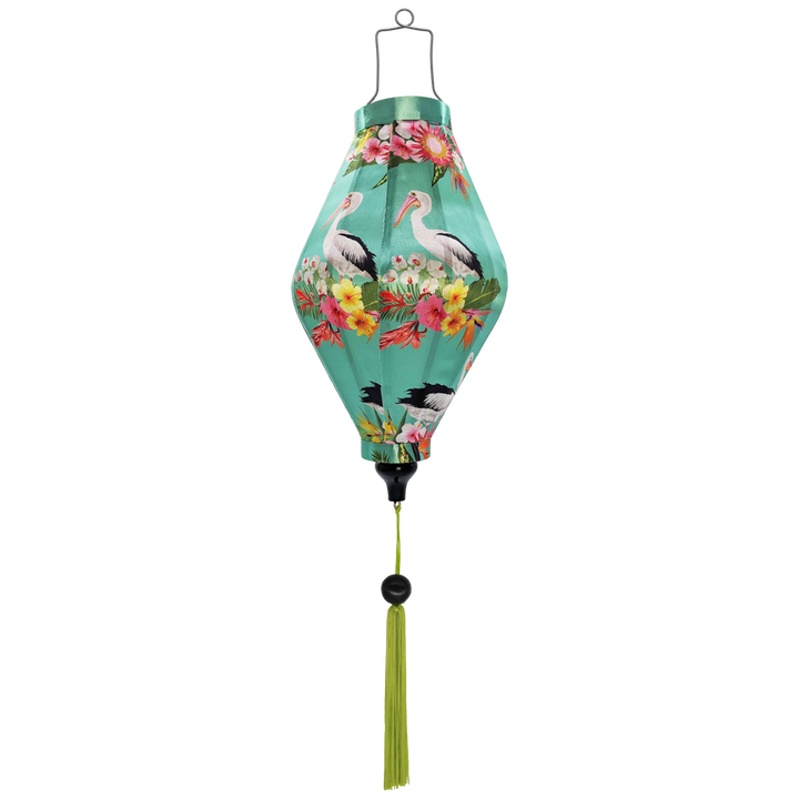 Tube shaped Vietnamese Hoi An Lantern with a print of majestic pelicans amidst exotic blooms of proteas, orchids, and hibiscus against a serene light mint green. Handcrafted by skilled Vietnamese artisans.