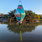Tube shaped Vietnamese Lantern hanging in Old Town with a print of pelicans, proteas, orchids, and hibiscus against a serene light mint green.