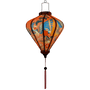 Glowing lantern with large phoenix bird rising with blue, gold, and pink wings.