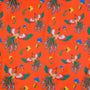 Close up of polyester and silk fabric featuring phoenix birds with green orange and white wings in flight amongst yellow and blue flowers on a bright orange background.