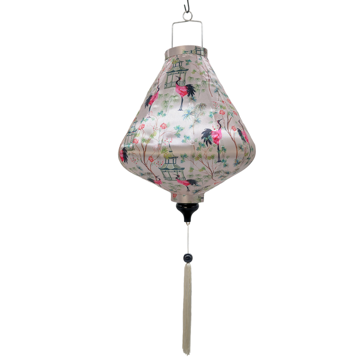 Teardrop shaped hanging lantern with floral and bird pattern on a light pink background and white tassel