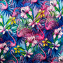 Polyester silk fabric with a print of pink flamingos, hibiscus, and frangipani flowers on a blue background. 