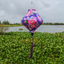 Lozenge shaped handmade purple Hoi An silk lantern with pink rose floral design, traditional Vietnamese decor and lighting.

