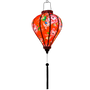 Glowing balloon shaped romantic red Hoi An lantern with delicate pink roses, ideal for Asian-inspired decor and special occasions.
