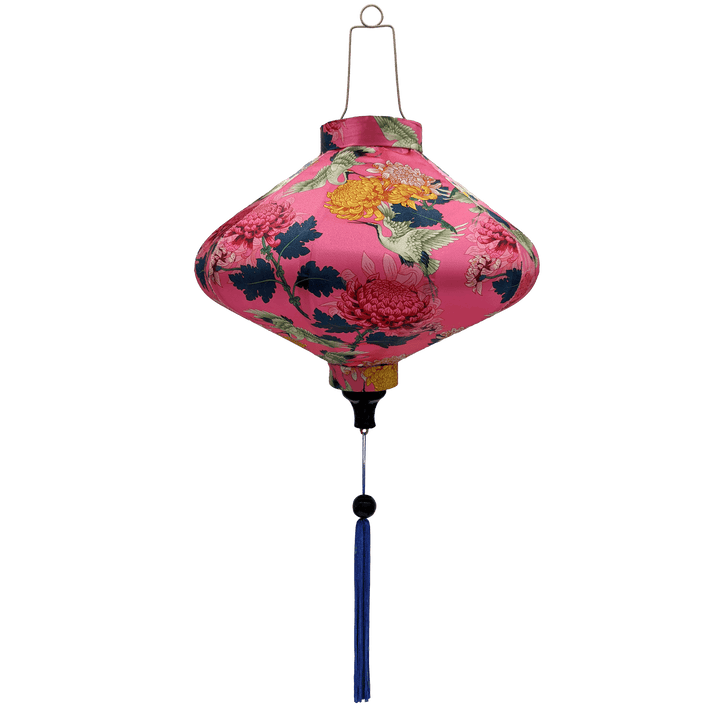 UFO shaped Vietnamese lantern with blue tassel, cranes, pink and yellow chrysanthemum flowers on a pink background. 