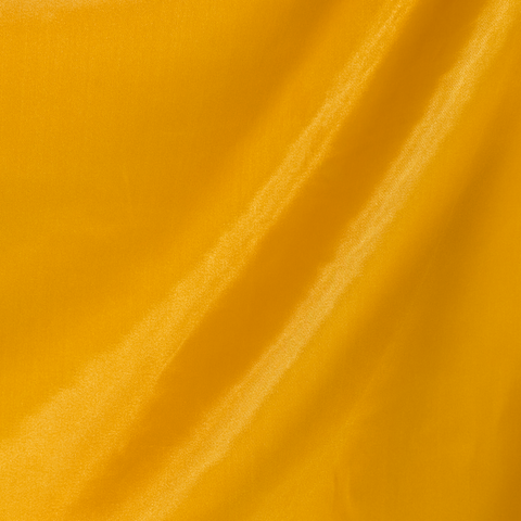Close-up of our polyester silk plain Gold fabric used to create Vietnamese silk lanterns.