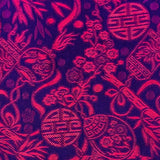 Close up of jacquard silk fabric with intricate patterns of bamboo, lanterns and symbols in red against dark purple background.