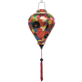 Balloon shape Vietnamese lantern featuring an intricate arrangement of multicolored flowers outlined in gold. 
