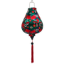 Garlic shaped Vietnamese lantern with print of red lotus flowers with against a deep, rich green background.