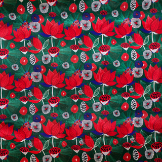 Close up of polyester silk fabric with print of red lotus flowers with against a deep, rich green background.