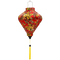 Diamond shape Vietnamese lantern with yellow tassel and red silk print of yellow flower blossoms with hints of green and white.