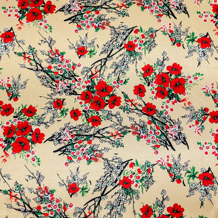 Polyester silk fabric with delicate floral print of red blossoms and elegant black branches on a cream background. 