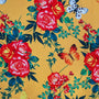 Floral pattern with red roses, green leaves, and butterflies on a yellow background