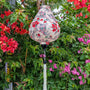 Garlic shape Vietnamese silk lantern handmade in Hoi An , Vietnam set against Bougainville with red flowers on luxury creamy silk fabric.