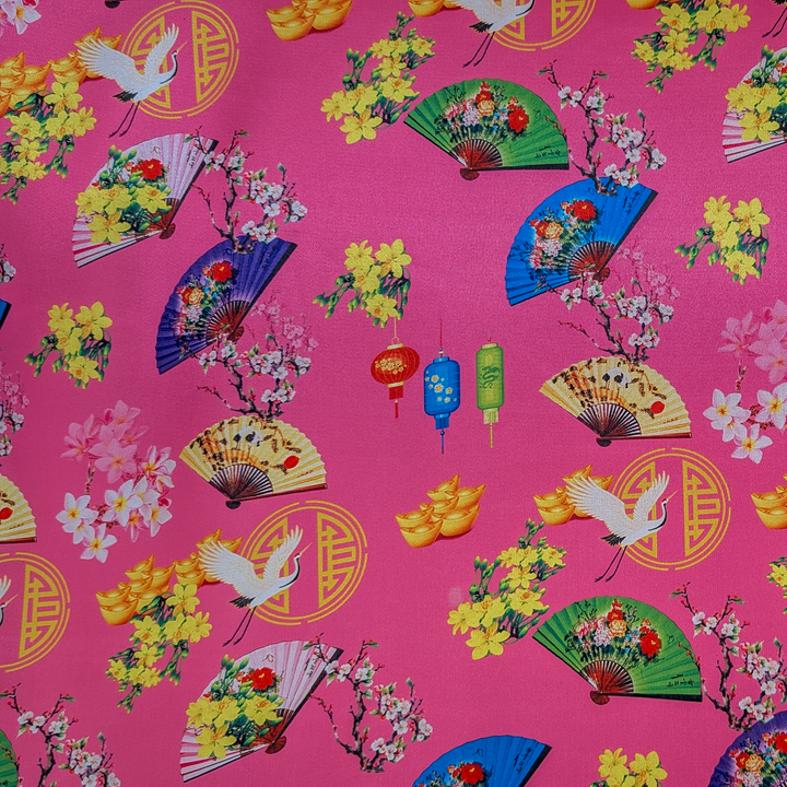 Colourful traditional pattern on a pink background with fans, flowers, and cranes.