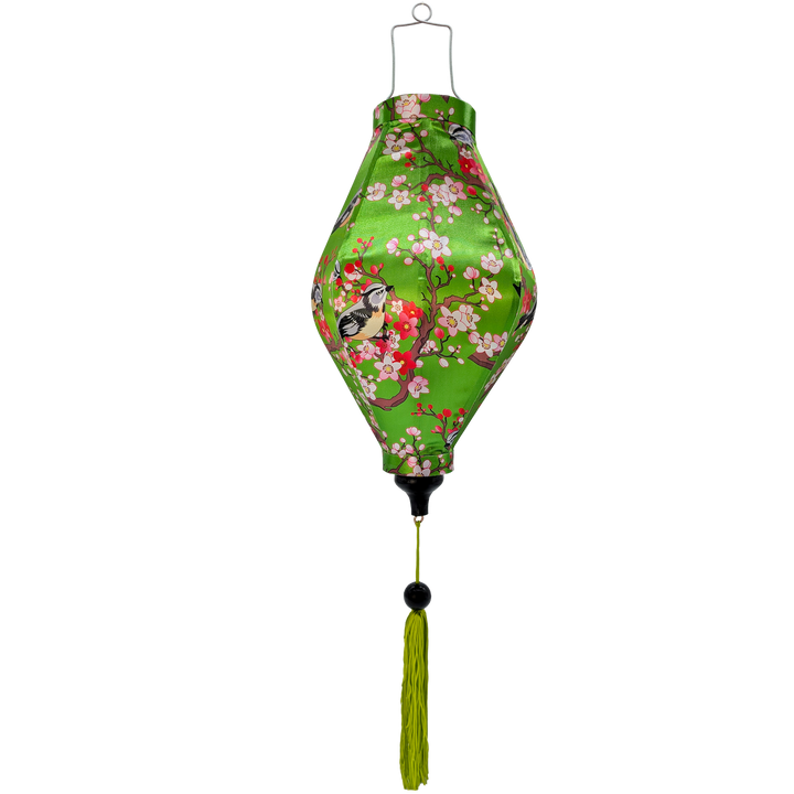 A handcrafted Hoi An silk lantern with a vibrant green fabric adorned with delicate swallows perched on a blossoming cherry tree, featuring pink and white flowers. The lantern has a unique elongated Tube shape and a matching green tassel for an elegant finish.