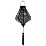 Glowing Teardrop shaped Vietnamese Hoi An lantern with flying swallows set against a bold black backdrop adorned with diamonds and yellow daisy flowers. 