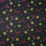 Polyester silk fabric with a print of flying swallows with striking red and blue wings set against a bold black backdrop adorned with diamonds and yellow daisy flowers. 