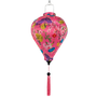 Balloon shaped lantern with floral patterns on a pink background and matching pink tassel 