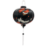 Round Vietnamese silk lantern with white tassel featuring a print of swooping white cranes and falling orange flowers against black backdrop.