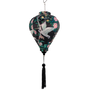 Balloon shaped black silk lantern with print of a large white crane and flowers with black tassel.