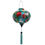 Round shape Vietnamese silk lantern featuring vibrant cranes & floral print surrounded by a lush flowers.