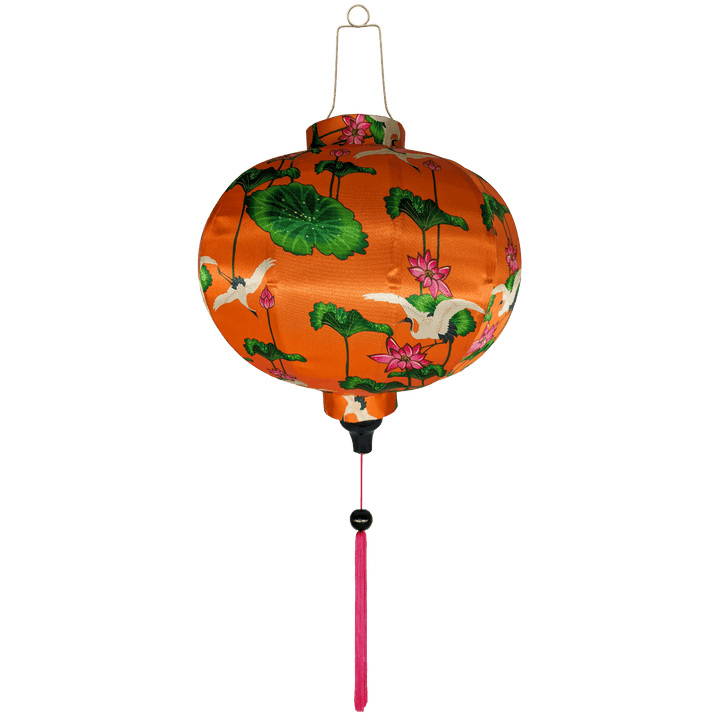 Round Vietnamese silk lantern with pink tassels and white cranes surrounded by pink lotus flowers.