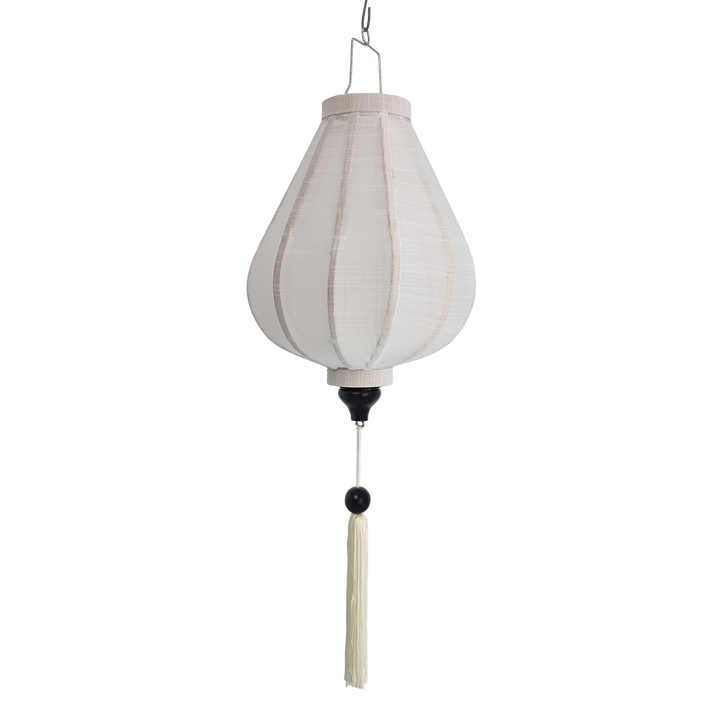 A hanging lantern with a white poly linen fabric and matching white tassel with a black bead, suspended 