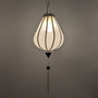 A hanging white poly linen lantern with a garlic shaped and a long white tassel.