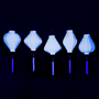 A row of glowing white silk lanterns in Balloon, Lozenge, Teardrop, Tube and Garlic shapes under  UV light.