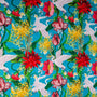 Vibrant fabric with cranes & floral print featuring graceful white cranes in flight, surrounded by a lush tapestry of red dahlias, golden chrysanthemums, and delicate blossoms. 