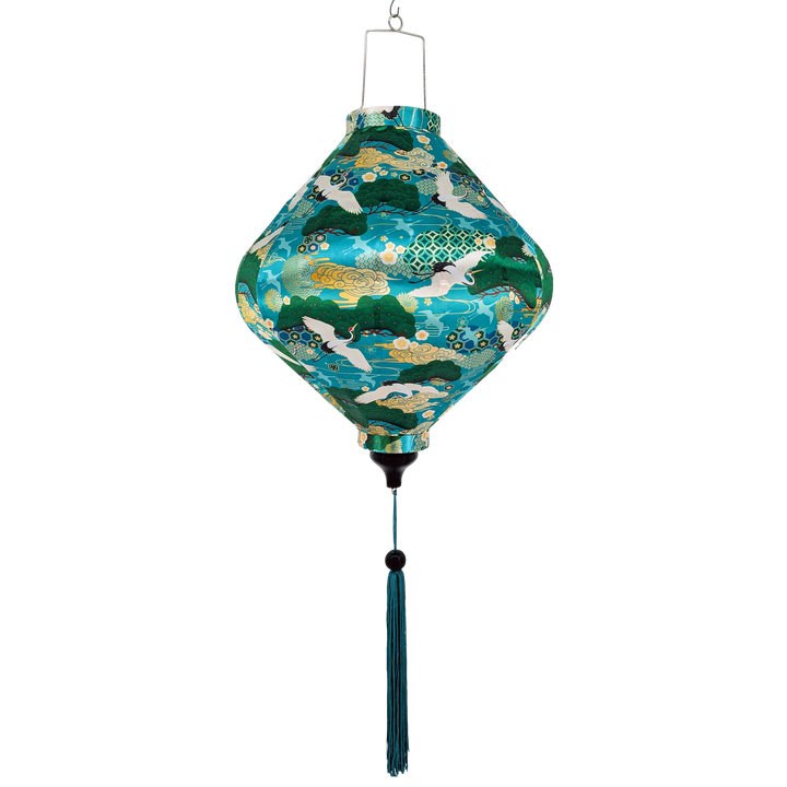 Lozenge shaped lantern with green and blue pattern on a teal blue background