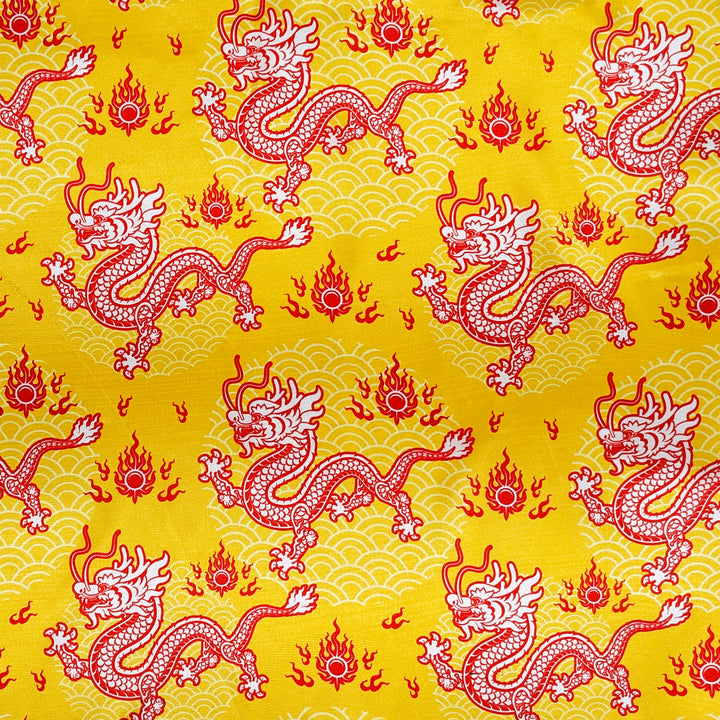 Polyester silk fabric featuring a design of dragons on yellow background used for creating silk lanterns.