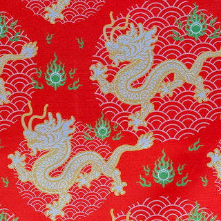Red fabric with gold dragons and green flames on a red background