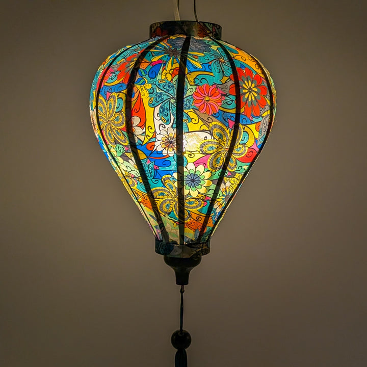 Glowing Balloon shape lantern featuring an abstract floral print with intricate swirls and bold hues of blue, red, yellow, and orange.