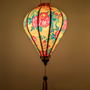 Glowing balloon silk lantern with roses and butterflies design on a yellow background