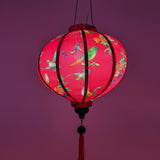 Glowing round lantern lit from an external light source creating a gorgeous hot pink hue.