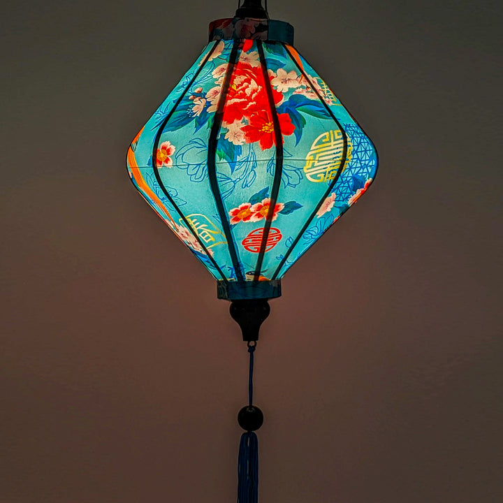 Up close of a glowing Lozenge shaped lantern with a light placed inside creating soft ambient light.