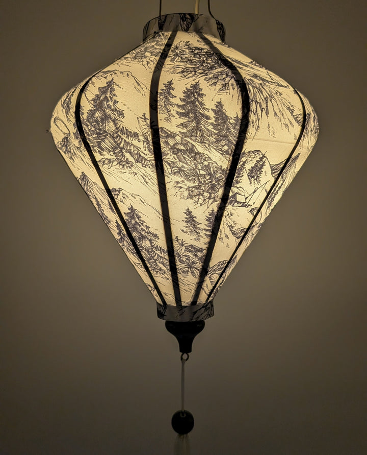 Lantern with tree pattern on a white background creating a warm soft glow.