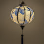 Glowing round lantern with Blue Koi print, featuring a pattern of intricately detailed koi fish swimming amidst silver swirling water currents. 