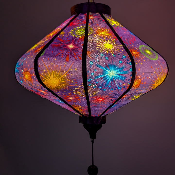 Glowing colourful lantern with fireworks design on a dark purple background