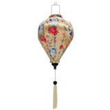 balloon shaped Vietnamese silk and bamboo lantern with print of graceful cranes, vibrant chrysanthemums, and delicate dragonflies on cream background.