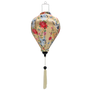 A balloon shaped Vietnamese silk lantern with cream tassel featuring a print of graceful cranes, vibrant chrysanthemums, and delicate dragonflies on cream background.