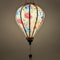 A balloon shaped glowing lantern with graceful cranes, vibrant chrysanthemums, and delicate dragonflies.