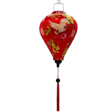 balloon shaped Vietnamese lantern with red headed cranes in flight, pink and yellow flowers, firecrackers and orange lanterns print and red tassel