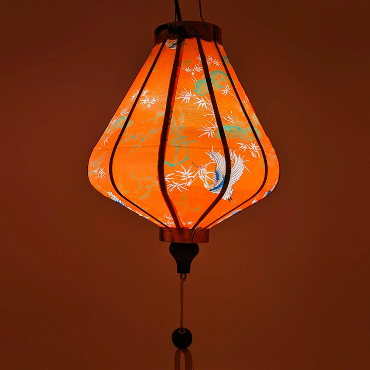 Glowing Vietnamese lantern with orange hue.