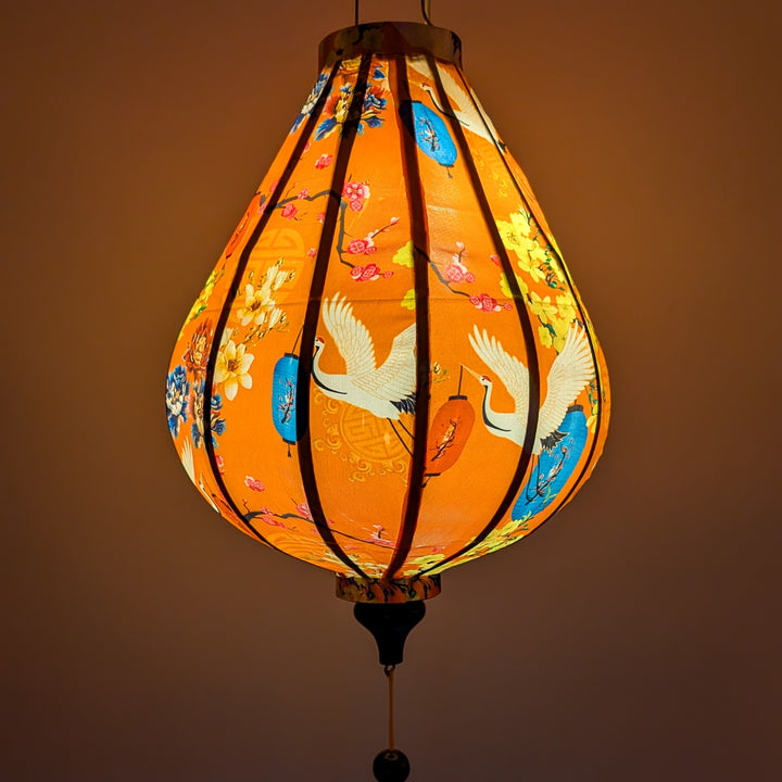 Glowing lantern with floral and bird patterns on an orange background