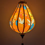 Glowing lantern with floral and bird patterns on an orange background