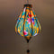 Glowing Garlic shaped lantern with exotic birds and palm leaves creating a warm cosy glow.