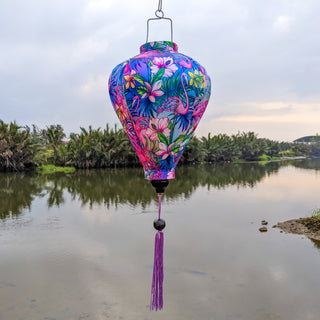 Balloon shaped lantern with flamingos in the wild outdoors.